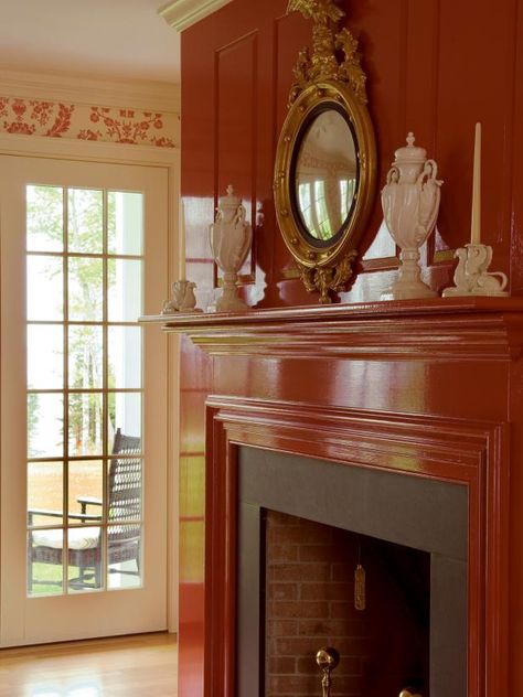 High-gloss red paint finishes off this paneled fireplace, a perfect complement to the floral wallpaper in the room. The shiny finish gives a more luxe, eye-catching look. French Country Fireplace, Fireplace Drawing, Sleek Fireplace, Country Fireplace, Wooden Beams Ceiling, Clean Fireplace, Fireplace Logs, Choosing Paint, Concrete Fireplace