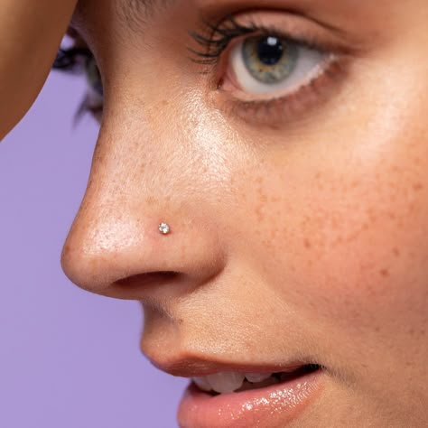 This little yet powerful stud offers a subtle shimmer and brilliance that you won't be able to resist. Just slightly larger than our "Dainty" 1.7mm diamond nose ring, the 2mm diamond shines a little brighter while still looking delicate and dainty, that's why we call it our "Ideal" nose ring . Our proprietary martini-prong setting is designed to allow the high-quality VS1 diamond to shine brilliantly while ensuring the stud lays flat within the piercing. This diamond nose ring offers the ultimat Clean Piercings, Makeup Gif, Small Nose Piercing, Nath Designs, Cute Nose Rings, Simplistic Jewelry, Trendy Silver Jewelry, Nose Piercing Ring, Cute Nose Piercings