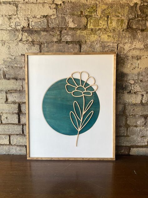 "Minimalist Leaf Wall Art: Painted white back ground with botanical Teal circle. Line art laser design, professionally framed with stain pine frame. Color: Green with stained wood accents Dimensions: 24\" height x 20\" Long x 1' Depth We are a family owned and operated studio, located in Noblesville, Indiana. We specialize in CNC and laser engraved signs and unique home décor. All pieces are individually painted, stained and framed. Because each piece of wall art is hand made and hand painted by Laser Cut Decor, Engraved Wood Signs, Lady Art, Small Wall Art, Laser Art, Laser Projects, Boho Nursery Decor, Wooden Wall Hangings, Laser Ideas