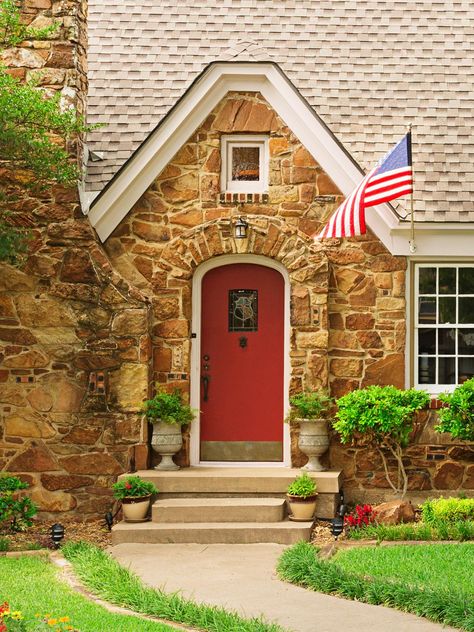 Ornate urns on either side of the door are filled with jasmine. “When they flower, I can smell them every time I come and go through the door,” says Erin. Tudor Front Door, Eugenia Topiary, Curb Appeal Inspiration, Red Brick House Exterior, Blue Siding, Brick House Exterior, Front Door Color, Florida Pictures, Curb Appeal Ideas