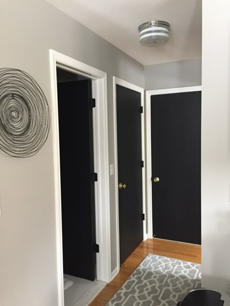 Black Doors Hallway White Trim, Flat Panel Black Doors, Black Interior Doors With White Trim Gold Hardware, Black Hallway Doors White Trim, Black Interior Doors Small House, White House Black Doors Interior, Hall With Black Doors, Black Stain Door Interior, Black Door Frames White Doors