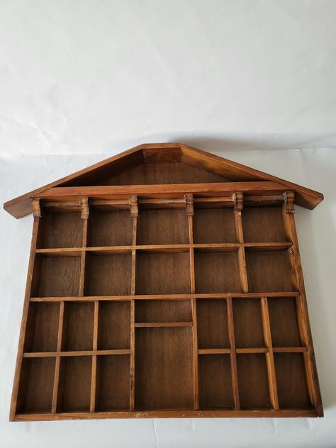 Do you have a collection of tiny things you would love to display? This house shaped shadow box hangs by two triangular hangers on the back. Little  treasures get to shine in this compartmented wall display. It measures approximately 20" in length and 17" inches wide and 1.5" deep. It is structurally strong with secure hooks. This distinctive house designed shelf offers a unique and captivating way to display and preserve memories and collectibles. It's not a traditional frame but rather a special piece of wall art creating a sense of depth and dimension that enhances the visual appeal for those  items you hold dear. Please take note that there are scratches because of its age and a few of the corbels are broken on the tips. 1970s House, Curio Display, Traditional Frames, Picture Frame Display, Tiny Things, Home Decor Pictures, Frame Display, Wall Display, Vintage 1970s