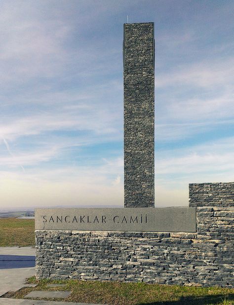 A tower of plain slate stands as the lone beacon to Sancaklar Mosque in Istanbul, a unique mosque which breaks away from the conventions of religious design in Turkey.  Designed by Emre Arolat Architects (EAA) and built in 2011.  Photo by Erdoğan Akman, via Flickr. Unique Mosque, Sancaklar Mosque, Mosque Modern, Monument Signage, Mosque Design, Site Sign, Sacred Architecture, Religious Architecture, An Architect