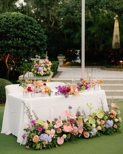 We are still swooning over these gorgeous florals by @bloomshakalaka and the stunning Sweetheart Table setup! Coordination & Design: @mdpevents Photographer: @dewittforlove Venue: @hardemanssecretgarden Florist: @bloom.shakalaka Videographer: @shannonkellyfilms Catering: @cbkcatering Cake: @tampabaycakecompany Rentals: @kateryaneventrentals Linens: @cdlinen DJ/Fusion Band: @irockyourparty Hair & Makeup: @hardtyoumore Transportation: @charterUP @dolphintransportation Newlyweds: @rtgive . . . ... Purple Sweetheart Table, Colorful Sweetheart Table, Floral Sweetheart Table, September Wedding Flowers, Wedding Decors, September Wedding, Table Setup, Sweetheart Table, Jewel Tones