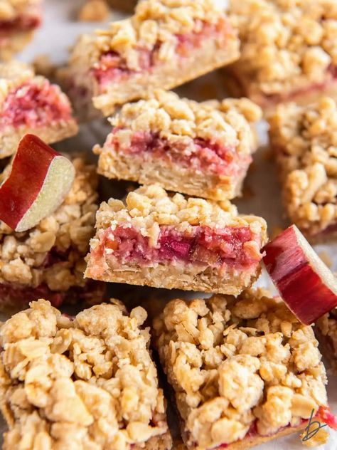 rhubarb crumble bar showing layers of crumb and filling leaning on another bar. Rhubarb Crumble Bars, Rhubarb Bars Recipes, Rhubarb Squares, Strawberry Rhubarb Bars, Almond Paste Recipes, Oat Crust, Rhubarb Bars, Blueberry Crumble Bars, Strawberry Rhubarb Crisp