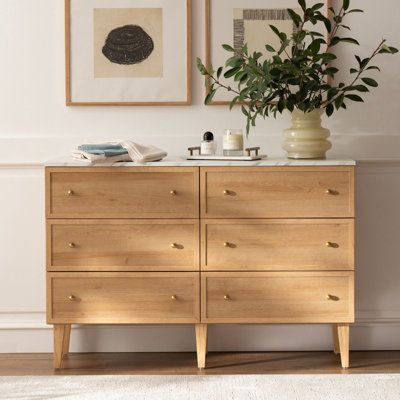 Upgrade your storage space and add a touch of elegance to your bedroom with our 6 Drawer Dresser. Its clean lines and neutral tones bring traditional style and natural warmth to any room. The quick and easy assembly process, sturdy engineered wood construction, and metal glides with safety stops make it a durable and practical choice for your busy lifestyle. Complete with sleek gold handles, this dresser is the perfect solution for all your storage needs. | Winston Porter Sivan 6 - Drawer Dresse Minimalist Bedroom Wood Furniture, Dressers Small Bedroom, Small Bedroom Drawers Ideas, Light Wooden Dresser, Dresser Under Window Bedroom, Light Wood Dressers, Japandi Dresser Bedroom, Ikea Björksnäs Dresser, Modern Organic Dresser