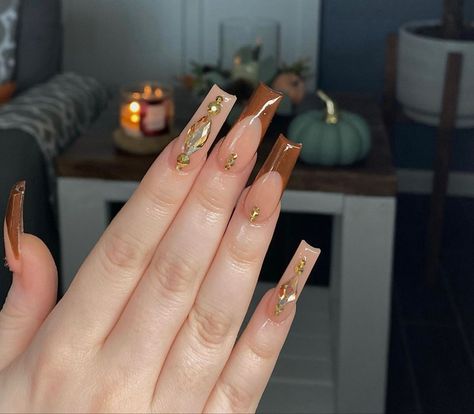 brown acrylic nails Gold Stones On Nails, Goddess Nails Square, Round Square Acrylic Nails, Brown Nails With Rhinestones, Brown And Gold Acrylic Nails, Square Acrylic Nails Fall, Brown Nails With Gems, Nude Bling Nails, French Tip With Rhinestones