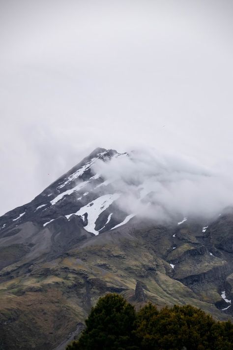 A mountain covered in snow and clouds on a cloudy day photo – Free Grey Image on Unsplash Taranaki New Zealand, Mount Taranaki, Mountain Images, Map Marker, Tree Images, Car Images, In The Clouds, Cloudy Day, Grey Wallpaper