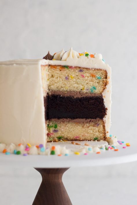 This funfetti layer cake is baked from scratch and includes a surprise chocolate layer inside! Topped with cream cheese frosting and scattered sprinkles, this homemade funfetti cake is perfect for celebrating a special birthday. The recipe includes instructions for baking the cake in 6 inch, 8 inch, or 9 inch pans. #funfetti #layercake Chocolate And Funfetti Layer Cake, Funfetti Cake With Chocolate Frosting, 8 Inch Round Cake Recipe, Chocolate Funfetti Cake, Funfetti Layer Cake, Funfetti Cakes, Homemade Funfetti Cake, Funfetti Frosting, 12 Inch Cake