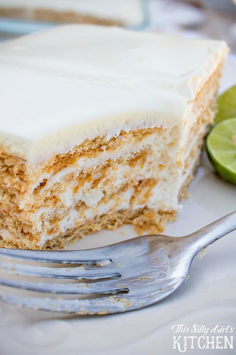 Key Lime Eclair Cake, layers of creamy filling bursting with key lime flavor between graham crackers, topped with vanilla frosting. Tastes just like a key lime pie, but much easier! from ThisSillyGirlsLife.com #keylimepie #eclaircake Key Lime Eclair Cake, Key Lime Recipes, Eclair Cake Recipes, Icebox Cakes, Lime Desserts, Eclair Cake, Ganache Frosting, Lime Recipes, Layered Desserts