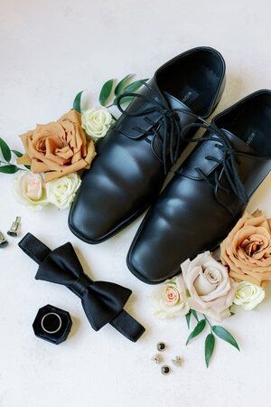 Groom wedding day details flat lay featuring black dress shoes, a bowtie, wedding ring, velvet ring box and flowers. Photo by Caitlin Alohilani Photography. Hexagon Arch, Bowtie Wedding, Glam Studio, Groom Details, Men's Wedding Rings, Wedding Day Details, Groom Shoes, Flowers Photo, Velvet Ring Box