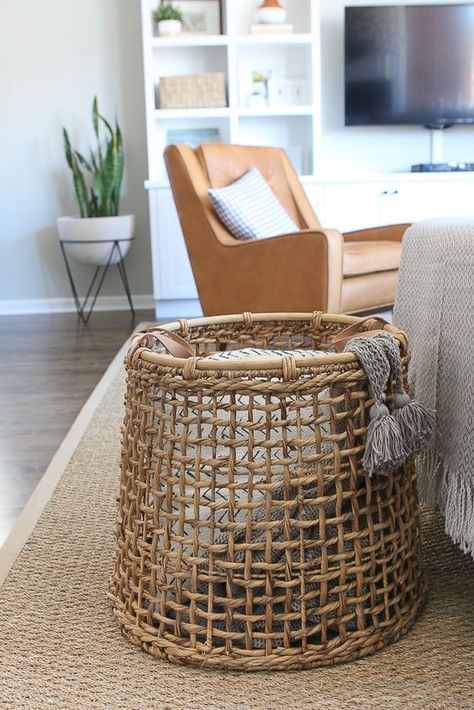 We love using baskets to corral all of the blankets in the living room. This is much better than having them all thrown around on the couch. Here's how to style throw blankets in your living room #throwblankets #throw #pillows #blanket #livingroom #livingroomstyle #diyplaybook Throw Blankets In Basket Living Rooms, Living Room Couch Throw Blanket, Couch Blanket Storage, Blanket Basket Living Room, Throw Storage Living Rooms, Storage For Blankets In Living Room, How To Display Blankets, Throw Blanket Storage Living Rooms, Decorative Baskets Living Room