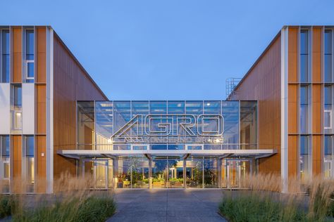 Moving the Head Quarters for a corporation to an outlying district is a very bold move, even if the mentioned enterprise is in agriculture service. The biggest challenge was to create a certain environment that would invite and attract customers, guests, and employees to the building even in the middle of the countryside. Industrial Complex Architecture, Agricultural Buildings, University Campus, Main Entrance, Facade Architecture, Site Plan, Farm Yard, Architect Design, Winter Garden