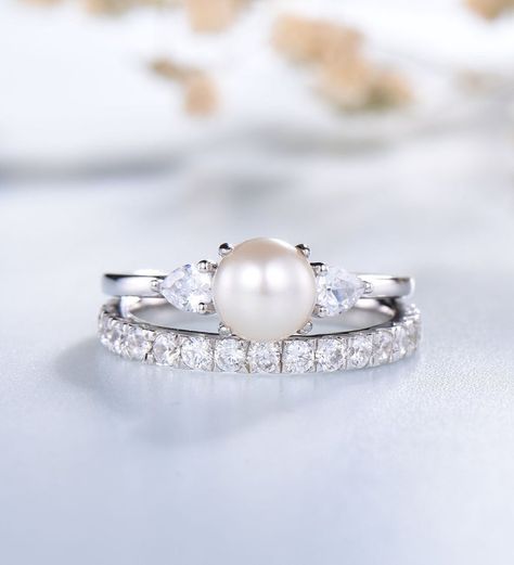 ♥ This Ring makes the perfect engagement or anniversary gift for her that will be treasured forever!
==================
*Item Description
==================

*Item :- Ring 2 Set

*Gemstone :- Pearl

*Color :- White

*Size :- 6.5 MM

*Shape :- Round

*Secondary Stone :-

*Gemstone :- Cubic Zircon

*Color :- White

*Style :- Minimalist

*Finishing :- Super Fine

*Ring Size :- US 4 to US 13

Occasion : Party , Anniversary , Wedding
==========================
OUR MAIN POLICY - “CUSTOMER IS OUR GOD” Pearl Wedding Ring Set Silver, Pearl Wedding Ring Set, Wedding Ring Pearl, Fire Opal Engagement Ring, Pearl Wedding Ring, Opal Engagement Ring Set, 14k Gold Wedding Ring, Silver Pearl Ring, June Birthstone Ring