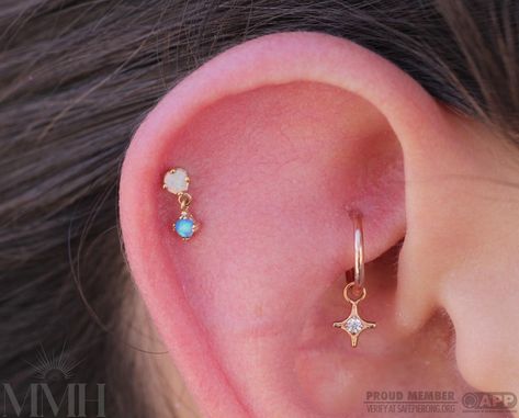 Alana added this fresh helix piercing with a white and blue opal Duet from @bvla, and restyled the rook with a Diamond charm from @anatometalinc #helixpiercing #rookpiercing #makemeholey #makemeholeybodypiercing #appmember #safepiercing #rookcharm #opal #mmhalana #bvla #anatometal @piercings.by.alana Pierced Jewelry, Helix Piercing, Diamond Charm, Blue Opal, Winter Collection, Different Styles, Piercings, Opal