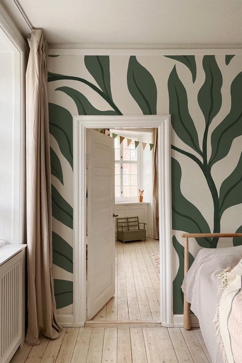 Large branches with leaves are covering the wall. in this Green leaves wallpaper. Playfulness with a classic twist that can be seen anywhere from a kids room to a café. Large green leaf wall mural for your boho or vintage interior update. Simple Living Room Mural Ideas, Mural Inside House, Plant Home Wallpaper, Wall Mural Botanical, Green Calming Wallpaper, Fun Wallpaper Accent Wall Bedroom, Forest Themed Interior Design, Guest Room Mural, Organic Accent Wall