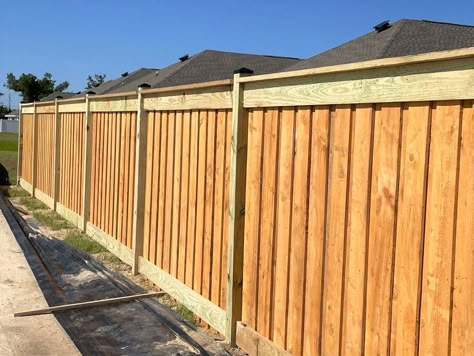 Board on Board Wood Fence with Top and Bottom Trim and Top cap completed by Shannon and his crew in Callaway. Board on Board Wood Fence is constructed with an overlapping pattern of pickets where every board is on the same side of the rail, but every other picket overlaps the first layer of wood pickets. Board on Board Wood fences offer complete privacy. In that case, if security is important to you, a Board on Board Wood Fence gives you the security you need. Diy Board On Board Fence, Board On Board Fence Ideas, Diy Wood Privacy Fence, Board On Board Privacy Fence, Wood Privacy Fence Ideas, Wooden Privacy Fence Ideas, Brushwood Fence, Board On Board Fence, Panel Design Ideas