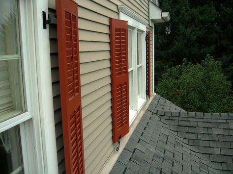 Close-up of functional ShutterLand exterior louvered shutters in a custom burnt orange paint. Orange Shutters, Burnt Orange Paint, Cottage Exterior Colors, Orange Front Doors, Bahama Shutters, Shutter Colors, Louvered Shutters, Shutter Designs, Vinyl Shutters