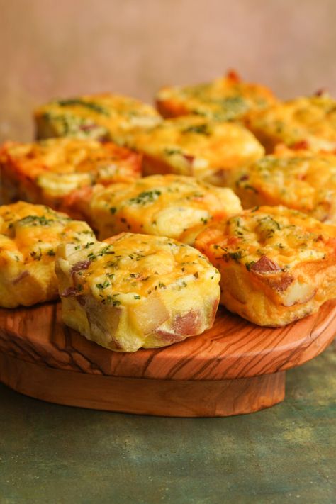 Skip the drive thru and make a batch of Starbucks Potato Cheddar Chive Bakes at home! They are a perfectly fluffy egg bite loaded with tender baked potatoes. Each bite gets topped with a layer of melty cheese and fresh chopped chives. Potato Cheddar Chive Egg Bake Starbucks Recipe, Copycat Starbucks Potato Egg Bites, Starbucks Potato Egg Bites Recipe, Egg And Potato Bites, Potato And Chive Egg Bites, Potato Cheddar Chive Egg Bites Starbucks, Starbucks Potato Chive Bake, Egg Potato Bake, Starbucks Potato And Chive Egg Bites Recipe