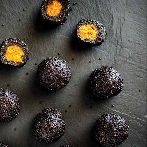 VEGAN | GLUTEN FREE | Makes 12 Balls   ingredients 150g black sesame seeds 150g dates 75g desiccated coconut 3 tablespoons black tahini 1/4 tsp salt  1 tsp vanilla extract 1 tbls maple or brown rice syrup 1 tbl spoon coconut oil 50 g dried mango 50g dried apricots Extra black sesame seeds for rolling   method Place t Black Sesame Dessert, Black Tahini, Raw Balls, Tahini Recipe, Dried Mango, Seed Balls, Lunchbox Treats, Desiccated Coconut, Black Sesame Seeds