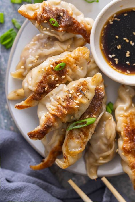 Stuffed with ground pork and cabbage, this Potstickers recipe far outshines anything you can buy at the store! Pan-fried then steamed, they're beautifully browned on the bottom and soft and tender on the top. Healthy Pot Stickers, Pork Pot Stickers Recipe, Potsticker Dough Recipe, Potsticker Dough, Ground Pork And Cabbage, Pork Potstickers Recipe, Homemade Potstickers, Potsticker Sauce, Potsticker Recipe