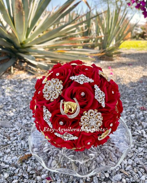 A beautiful charro themed bouquet for your special occasion. This bouquet is handmade to order with red silk roses, gorgeous sparkling gold brooches and rhinestones. We can do it in different colors. Please select the color of your choice. Please message me if you would like silver brooches instead.  *This bouquet is 10 inches in diameter* Please contact me with any questions! :) White Quince Bouquet, Quince Bouquet Red, Red Quince Bouquet, Black Quinceanera Theme, Red Quince Theme, Gold Quinceanera Theme, Quince Bouquet, Red And Gold Quince, Charro Theme