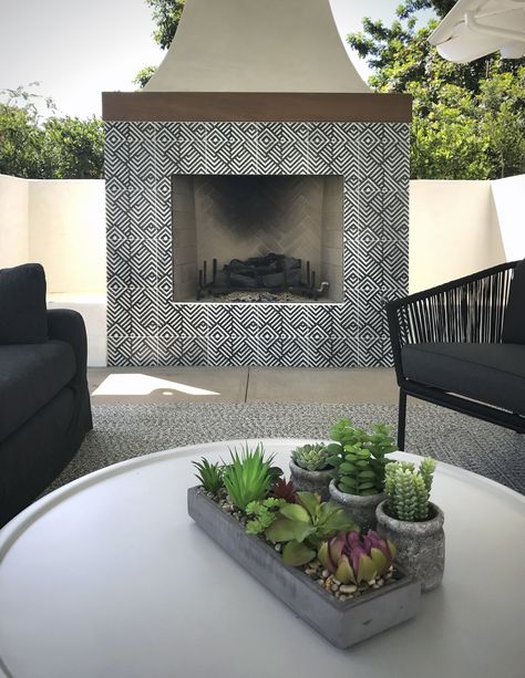 This outdoor fireplace features the patterned tile, Waterways from our in-stock collection on 12x12 carrara marble.  This custom tile makes the perfect outdoor living space unique and bold with the geometric black lines contrasting with the high end white marble. Artisan Stone Tile, Modern Outdoor Fireplace, Tiles Designs, Outdoor Fireplace Designs, Exterior Wall Tiles, Wall Decoration Ideas, Pattern Tiles, Outdoor Fireplace Patio, Wall Tiles Design