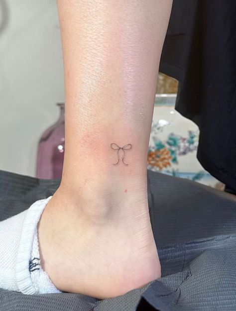 Ankle Bow Tattoo, Bow Tattoo On Ankle, Tattoos That Represent Femininity, Bow Ankle Tattoo, Bow Tattoo Meaning, Cheer Bow Tattoo, Bow Tattoo Placement, Fine Line Bow Tattoo, Tiny Bow Tattoo