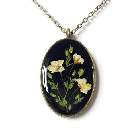 An unique real flower resin necklace. Want to gift your bridesmaids or you near and dear ones with a amazing piece of nature? Then you have got the right one. This exceptional real flower forest necklace has been created with delicate herbs and flowers collected from majestic mountains of Himalaya and then carefully processed to preserve intrinsic colour and shape. Dried and pressed real flowers were then handcrafted to unique design and embedded into high quality resin to provide everlasting va Resin Pressed Flower Necklace, Dried Flower Necklace Diy, Wedding Flower Necklace, Resin Flower Jewelry, Real Flower Jewellery, Flower Forest, Forest Necklace, Flower Resin Jewelry, Herbs And Flowers