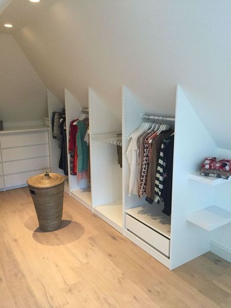 a simple and small Scandinavian attic closet with a dresser and open storage compartments that built into the attic nook Scandinavian Attic, Attic Storage Ideas, Small Attic Spaces, Attic Nook, Attic Bedroom Storage, Attic Wardrobe, Bedroom Built In Wardrobe, Attic Bedroom Designs, Attic Closet