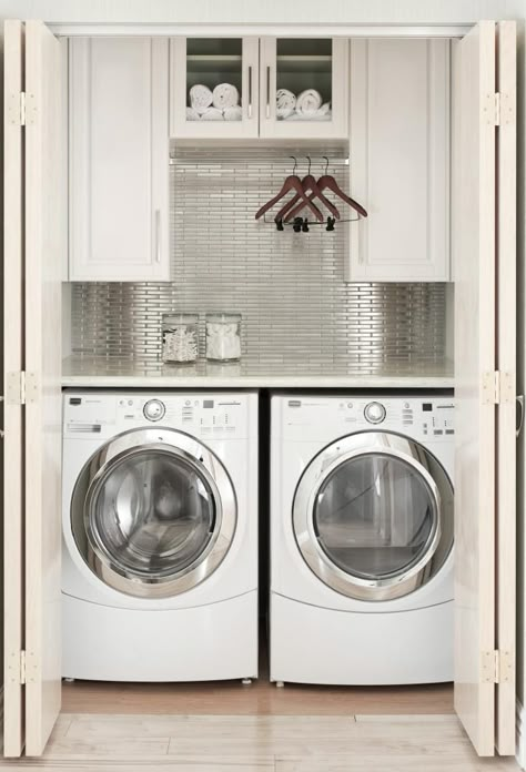 Laundry Room Closet Design Idea, Remodelista - this is about the same size as my laundry area but much more stylish! Laundry Room Ideas Closet Hanging Clothes, Laundry Room Ideas With Hanging Rod, Hanging Rod In Laundry Room Cabinets, Laundry Room With Bar To Hang Clothes, Washer And Dryer Small Space Ideas, Small Laundry Area In Kitchen, Laundry Closet Open Shelving, Laundry Cabinet With Hanging Rod, Laundry Room With Rod Hanging Clothes