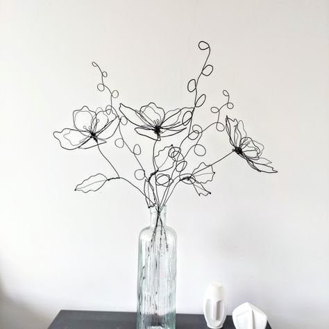 Handcrafted Wire Flower Bouquet - Minimalist Metal Floral Art Enhance your home decor with this beautiful handcrafted wire bouquet, featuring 3 delicately shaped flowers and 3 complementary stems. This minimalist metal sculpture adds an artistic touch to any space, perfect for showcasing on a table, mantel, or in a favorite vase. Product Details: Sizes: Flowers: 45 cm Stems: 55 cm Material: Crafted from durable black annealed wire. Features: Handcrafted Excellence: Each piece is meticulously sha Flower Bouquet Minimalist, Wire Flower Bouquet, Wire Bouquet, Metal Wire Sculpture, Wire Figures, Metal Flower Art, Metal Wire Art, Sculptures Sur Fil, Chicken Wire Art