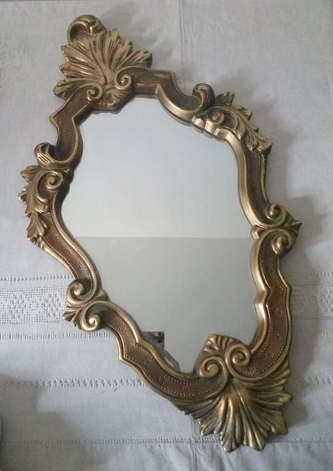 Large old rococo style mirror Golden wood mirror Decorated with scrolls and foliage Very pretty patina Object from the 1950s/1960s Dimensions: height 68 cm x width 38 cm A hanging hook on the back The back of the frame has been redone Paris spirit of the 1950s For a boudoir-style atmosphere