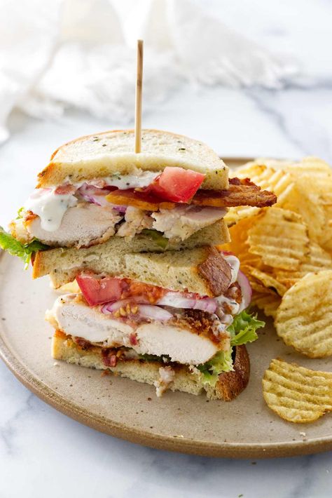 This chicken bacon ranch sandwich is a full meal deal. Crisp chicken, smoky bacon, cheese, and fresh veggies get slathered in ranch dressing. Ranch Sandwich, Chicken Bacon Sandwich, Chicken Bacon Ranch Sandwich, Crisp Chicken, Sandwhich Recipes, Creamy Ranch Dressing, Creamy Ranch, Bacon Sandwich, Chicken Sandwich Recipes