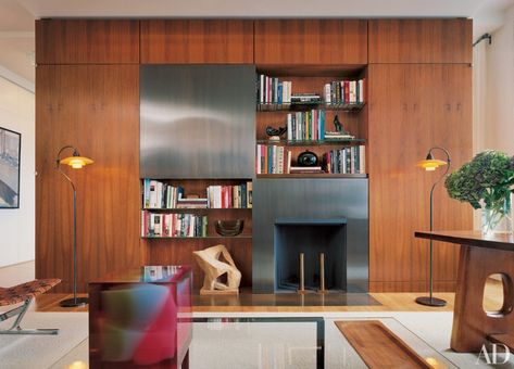 hidden tvs - TV concealed behind a sliding bronze pane set into a wood partition cabinet in a New York apartment study by Shelton Mindel & Assocs. - AD via Atticmag Hidden Tv Ideas, Tv Solutions, Hide Tv, Wall Applications, Hidden Tv, Tv Ideas, Manhattan Apartment, Terrazzo Flooring, Wall Units