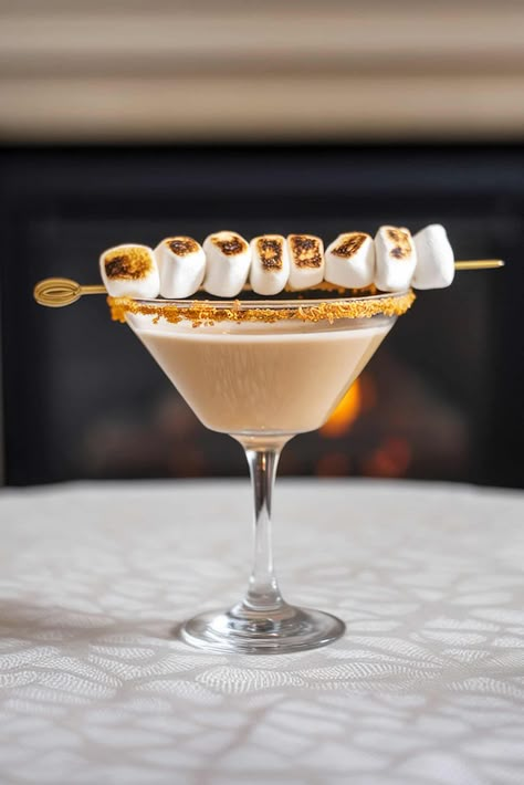 Indulge in the cozy charm of the Toasted Marshmallow Martini! This creamy cocktail blends rich marshmallow flavors with smooth vodka, topped with a perfectly toasted marshmallow. Perfect for autumn gatherings or a cozy night in, this drink will warm your heart and delight your taste buds. Try it today! #ToastedMarshmallowMartini #CocktailRecipes #FallDrinks Marshmallow Martini, Toasted Marshmallow Syrup, Marshmallow Flavors, Candy Cane Cocktail, Marshmallow Syrup, Holiday Dessert Drinks, Christmas Cocktails Vodka, Lemon Drop Martini Recipe, Marshmallow Vodka