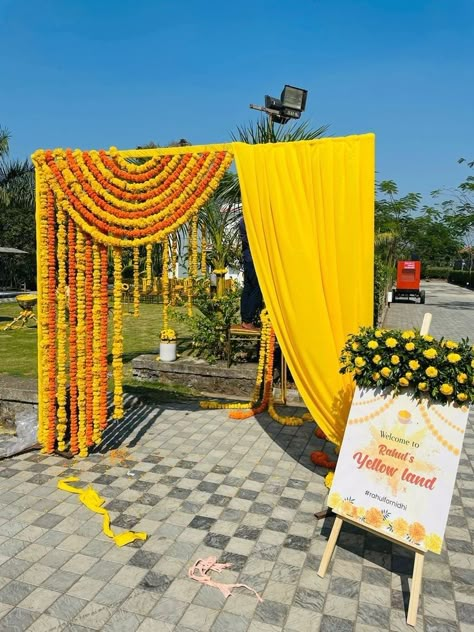 Think Event Think Bazaar Haldi Decoration With Flowers, Haldi Gate Decor, Haldi Entrance Decoration Ideas, Haldi Arch Decor, Haldi Gate Decoration, Haldi Decoration Ideas Outdoor, Haldi Mandap Decoration, Indoor Haldi Decor, Haldi Entrance Decor