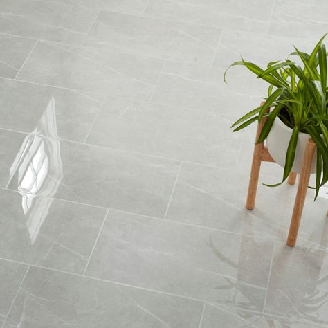 The Alabaster Blanco porcelain wall and floor tile instantly elevates any space by offering the lavish appearance of marble with the durability and easy maintenance of porcelain. This 12" x 24” tile displays soft grey veining against a mid-tone grey background for an authentic marble look. The polished finish provides an elegant touch of glamour, while rectified edges allow for a more sleek overall appearance. | Alabaster Blanco Wall and Floor Tile - 12 x 24 in | Wall Tile | Porcelain | The Tile Gray Porcelain Tile Floor, Marble Tile Bathroom Floor, Large Floor Tiles, Utility Room Designs, Marble Bathroom Floor, Porcelain Tile Bathroom, Marble Tile Bathroom, Gray Porcelain Tile, Grey Floor Tiles