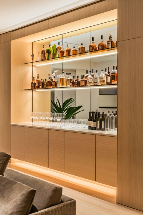 Ever dreamed of a seamless, custom bar setup? Built-in shelves blend effortlessly with your home’s architecture, adding a polished and luxurious touch to your bar area. I’m obsessed with how mirrors and backlighting can highlight your glassware and liquor bottles, creating a chic display. It’s the perfect solution for modern home bars or niche spaces. Ready to create a sleek and sophisticated look in your home? Kitchen With Built In Bar Area, Built In Cocktail Bar, Den Bar Ideas, Home Bar Wall Ideas, Built In Bar Ideas For Home Living Rooms, Wine And Liquor Wall Rack, Alcohol Display Ideas, Drinks Cabinet Ideas Home Bars, Mini Bar Ideas For Home Living Rooms