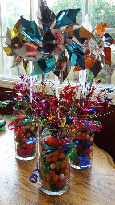 Pinwheel centerpiece Using Ballon weights, vase and gumballs. Cheap and easy. Easy Candy Centerpieces, Fun Birthday Centerpieces, Simple Birthday Party Centerpieces, Classy Carnival Theme Party, Abc Centerpieces, Easy Birthday Centerpieces, Candy Centerpieces For Party, Candyland Centerpieces Ideas, Candy Centerpiece Ideas