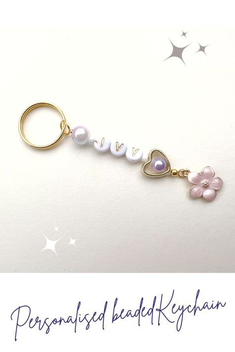 A personalised beaded keychain with a pink flower charm. The keychain is made with a variety of beads including pearl beads and gold heart. The pink flower charm is attached to the keychain. Name Keychain, Beaded Keychain, Beaded Keychains, Personalized Keychain, Custom Keychain, Flower Charm, Etsy Handmade, Pink Flower, Keychains