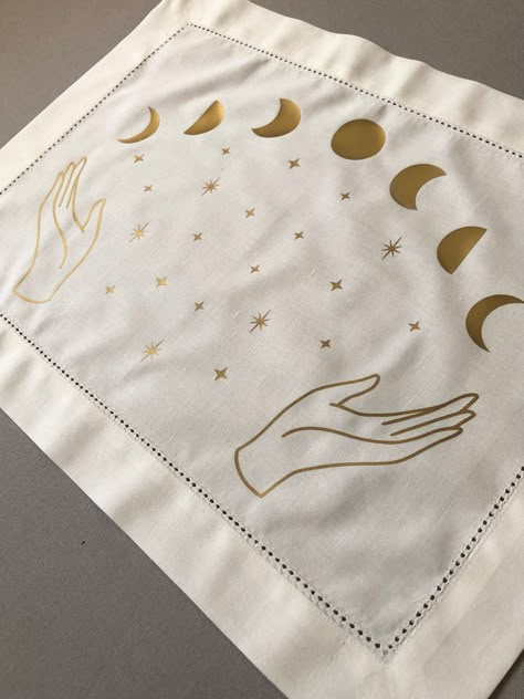 "Please note - listing is for altar cloth only. Other items pictured are not included. Adorn your sacred space with this altar cloth honoring of the phases of the moon. Use it for tarot readings, meditation, spellwork, or to display of your beautiful witchy treasures. DETAILS 19\" wide x 14\" tall 75% cotton, 25% linen High quality permanent adhesive vinyl decal (Oracal 651) in gold CARE INSTRUCTIONS Dry clean only Do not wash Do not iron Indoor use only Store flat, rolled, or hanging to prevent Tarot Card Altar, Witchy Altar Ideas, Witch Altar, Mini Altar, Spirit Store, Tarot Cloth, Witches Altar, Moon Witch, Witchcraft For Beginners