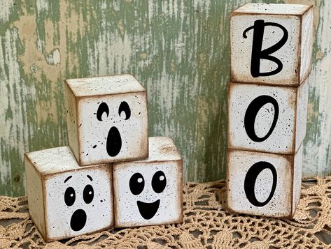 Cute Farmhouse Ghost decor for your rustic halloween. You can choose between one set of ghost blocks, one set of 'BOO" blocks or both sets together. Blocks measure 2"x2". Blocks are not attached. Blocks Painted white, sanded and distressed to add to it's farmhouse charm. Faces and letters are high quality vinyl.  NoteThis is a stock photo so pieces will vary slightly from original photos.