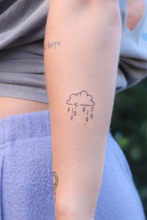 38 Simple Tattoos You Can’t Go Wrong With Dainty Rain Tattoo, Lightning Bolt Tattoo Design, Raincloud Tattoo Simple, Easy Tattoos To Draw For Men, Rain Storm Tattoo, Simple Cloud Tattoo, Raincloud Tattoo, Pretty Simple Tattoos, Storm Cloud Tattoo