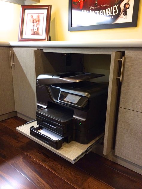 Printer hide - away!   Many of us are using our printers less these days and in a cozy home we generally do not want to see this large machinery out to clutter a fine designed home office. Pocket doors and sliding shelf makes for a neat hide-away for any printer or machine.  Created #HomeOffice by #Malka and #RCCabinetsandClosets of #Sonoma  #OfficePrinter #HomeOffice #InteriorDesign #ProfessionalOrganizer #ProfessionCabinetDesign #PrinterShelf #PrinterCabinet Hiding Printer In Home Office, Hide Printer In Office, Large Printer Storage Ideas, Home Office With Printer, Office Pocket Doors, Printer Table Ideas, Printer Storage Ideas, Office Decor Professional Work, Printer Drawer