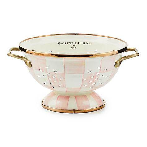 For kitchen preparations with personality, look no further than the Small Rosy Check Enamel Colander. The steel underbody makes this number a workhorse, and the hand-painted, color-dragged checks in a range of rosy hues and antiqued brass-finish handles give some pizzazz to scrubbing potatoes and sass to straining salads. | Rosy Check Small Colander Pink Kitchen Supplies, Splatter Screens, Enamel Cookware, Kitchen Strainer, Decorative Kitchen, Up House, Pink Kitchen, Cute Kitchen, Mackenzie Childs