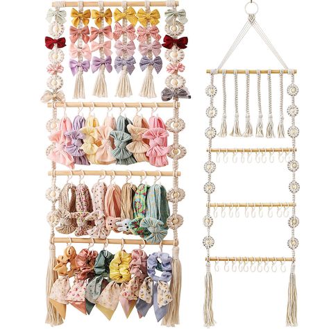 PRICES MAY VARY. Bow and Headband Organizer: This meticulously hand woven hanging organizer from GRDYEAAR provides a versatile solution for storing your little one's hair bows, headbands, hair clips and ribbons, making it an excellent choice as a bow holder, baby bow organizer and headband holder. 51 inches high * 14 inches wide Saves space: As a one-stop storage solution, this bow holder for girls' hair bows helps declutter your space by providing an organized place to store hair accessories. E Diy Baby Bow Holder, Dollar Tree Nursery Decor, Bow And Headband Organizer, Claw Clip Organizer, Hair Accessory Organizer, Diy Baby Bows, Clip Organizer, Bow Storage, Toddler Hair Accessories