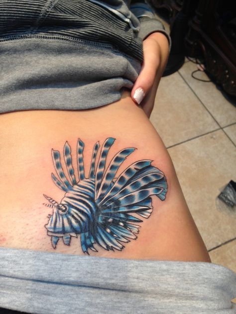 The Lionfish is one of the most beautiful fish in the ocean. They have 14 venomous spines on their fins, usually native to the Indo-Pacific, they have invaded the Caribbean and Southern Atlantic regions in recent years. I live on an island and wanted a ocean tattoo, my boyfriend suggested this  to me because although they are beautiful and small, they are dangerous, fearless, and uncontrollable.  The way he sees me, and I like to see myself. :) Lion Fish Tattoo, Lionfish Tattoo, Aquatic Tattoo, Thigh Piece Tattoos, Classy Tattoos For Women, Fish In The Ocean, Meaningful Tattoos For Women, Ocean Tattoos, Pieces Tattoo