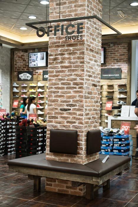 Retail Store Seating Area, Retail Column Design, Column Seating Design, Transparent Signage, Column Signage, Retail Lighting Design, Hanging Signage, Shoes Hanging, Column Ideas