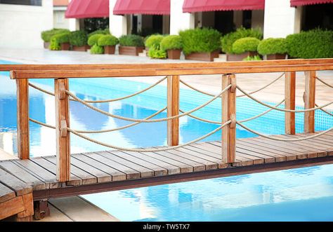 Wooden bridge over swimming pool in luxury hotel Stock Photo Pool Bridge, Lynn Canyon, Small Bridge, Bali Villas, Luxury Swimming Pools, Thermal Spa, Natural Swimming Pool, Wooden Bridge, Blue Sky Background